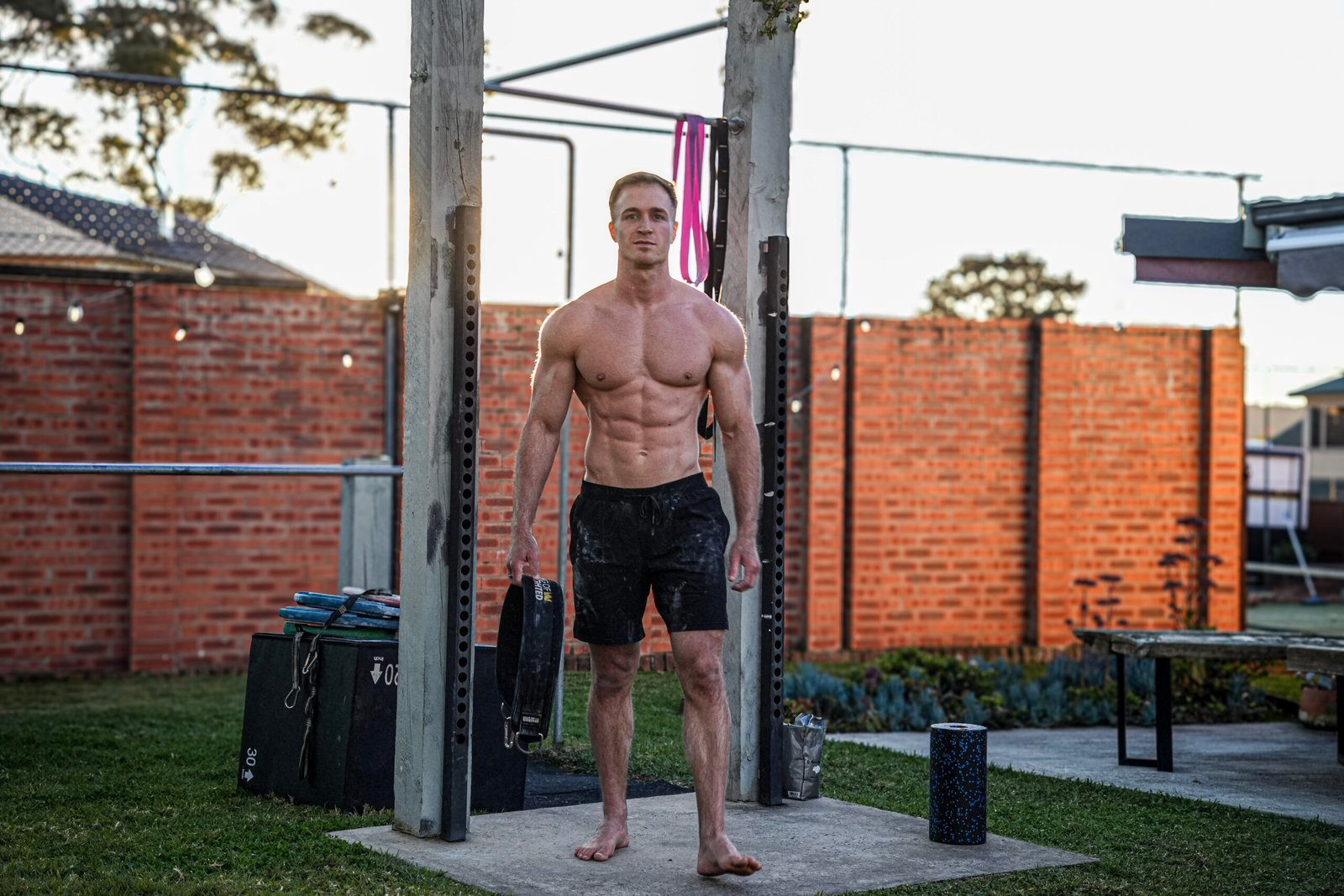 Jake Williams training outdoors with a weight plate